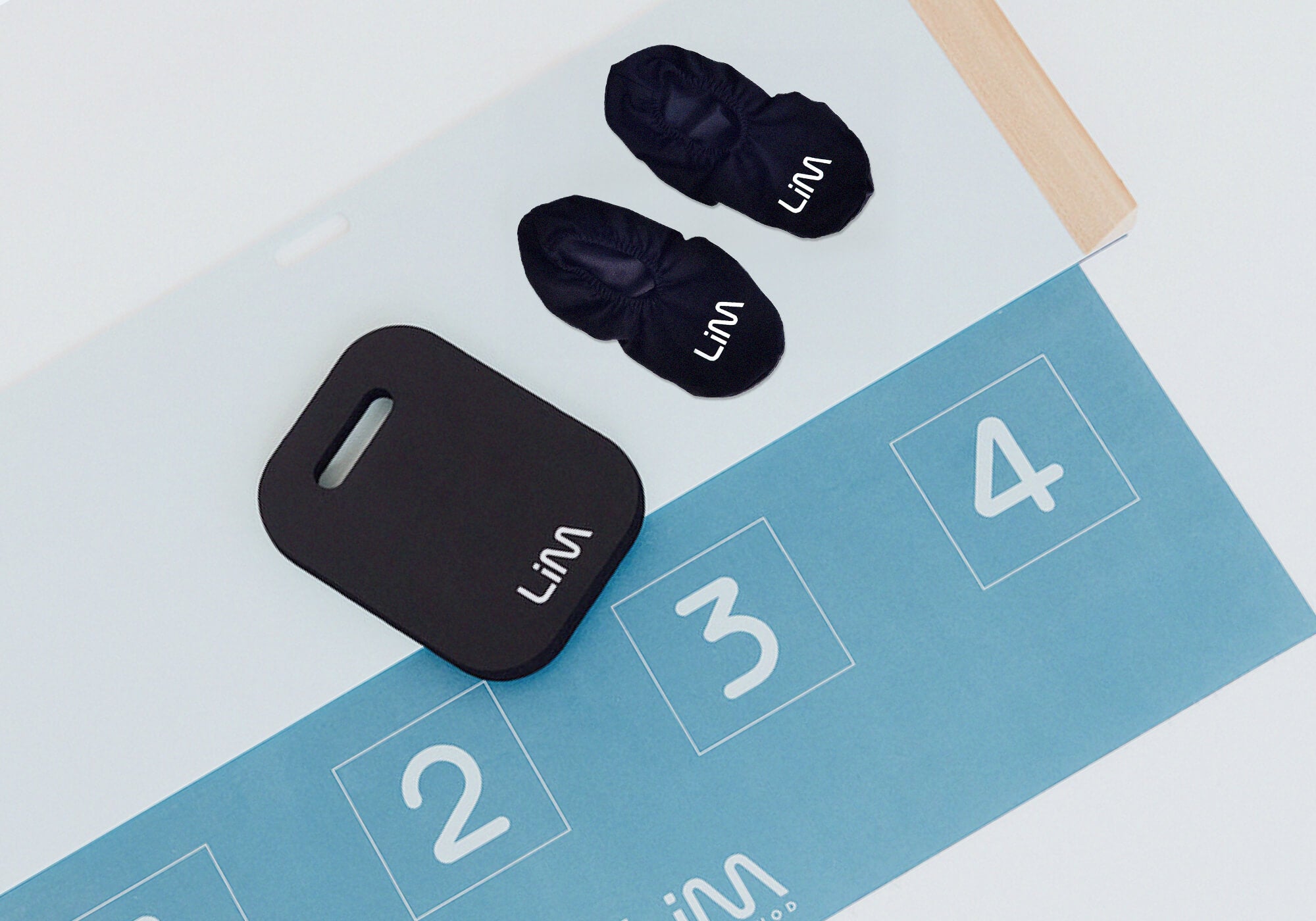 A blue LiM Method sliding board and accessories that are available for purchase for pelvic floor support.
